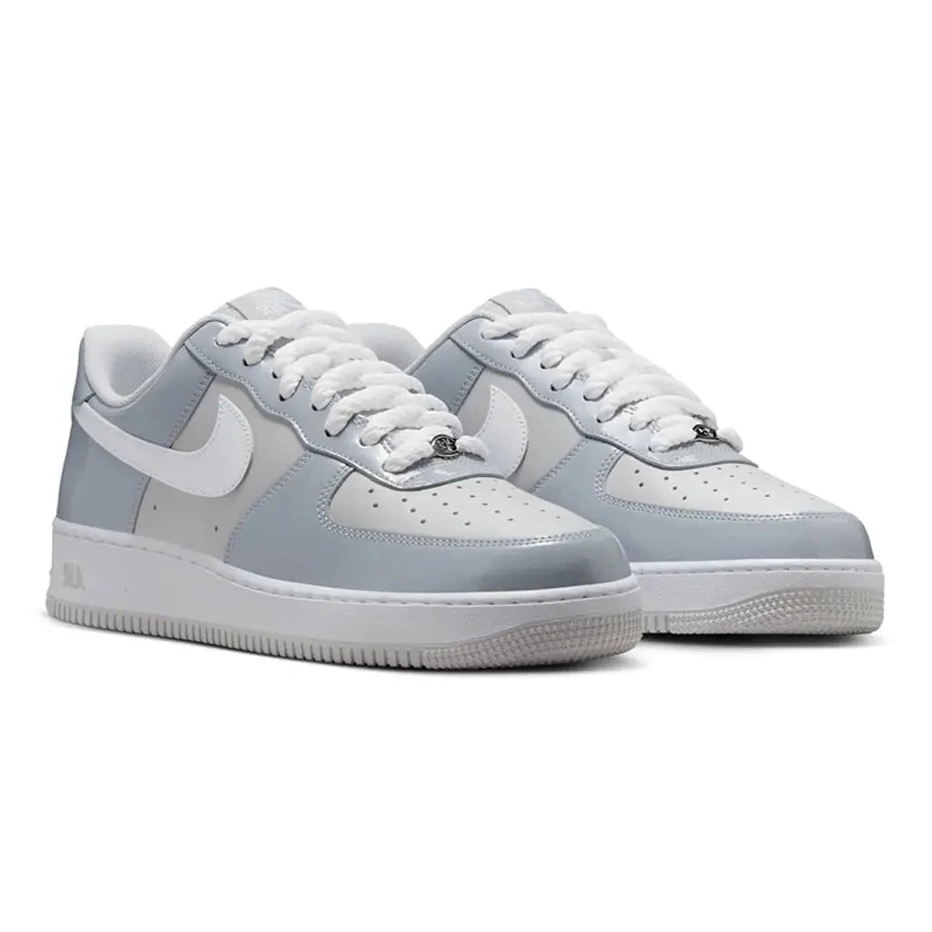 Nike Air Force 1 Low Wolf Grey Vast Grey pair front three-quarter view showing grey panels and white Swoosh