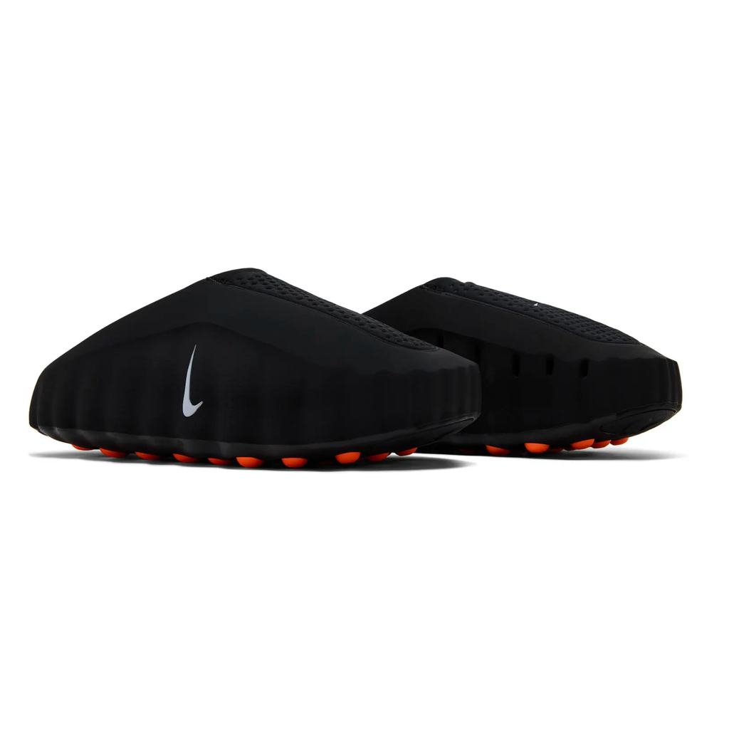 Nike Mind 001 Black - rear three-quarter pair view showing sculpted black foam upper, perforated knitted heel panel, silver Nike Swoosh and orange sensory nodes on outsole