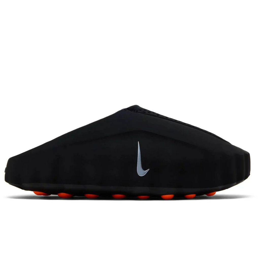 Nike Mind 001 Black - lateral side profile on white background showing sleek black foam shell, silver Nike Swoosh, perforated upper and orange sensory nodes visible along outsole edge