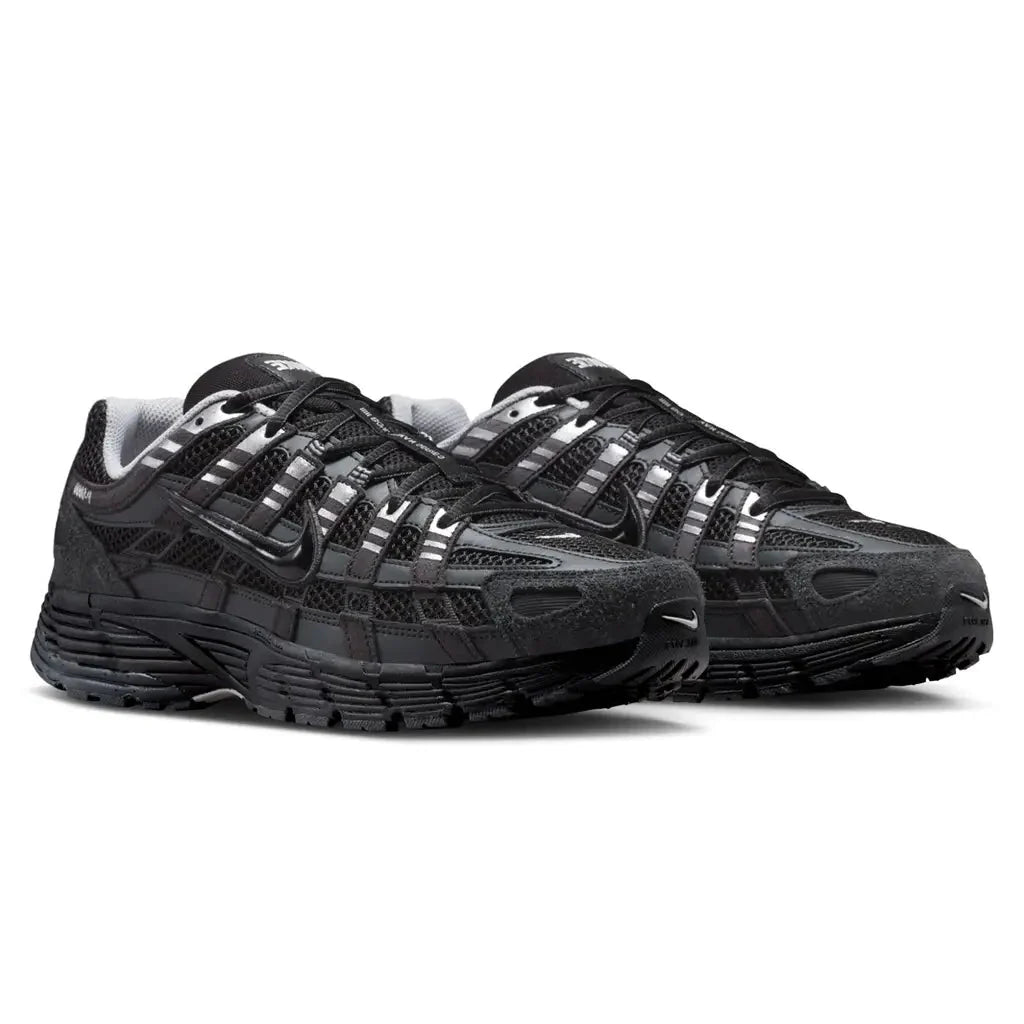 Nike P-6000 Suede Anthracite Metallic Silver pair front three-quarter view on white background showing black mesh, metallic silver straps, and anthracite suede mudguard